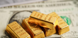 Gold bars on US dollar banknote money