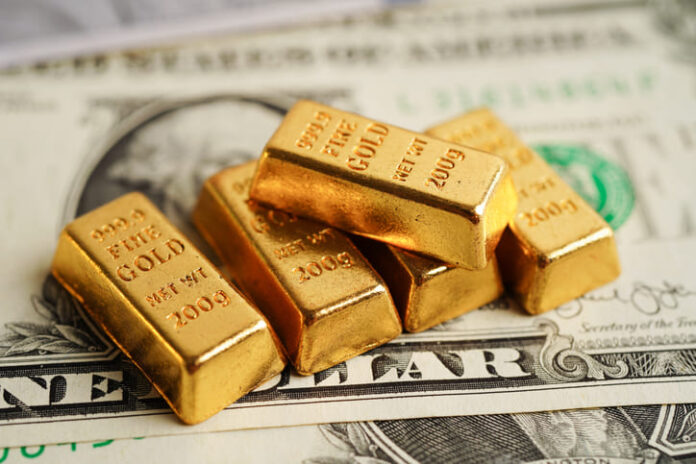 Gold bars on US dollar banknote money