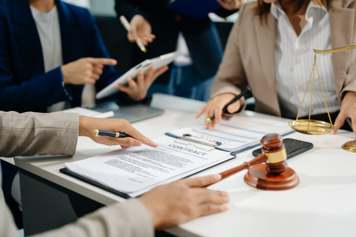 business people and lawyers discussing contract papers sitting at the table. Concepts of law, advice, legal services. Legal Contract Audits
