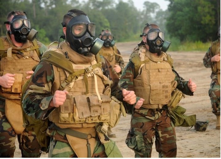 US Navy Seabees jog during an exercise with M40s worn