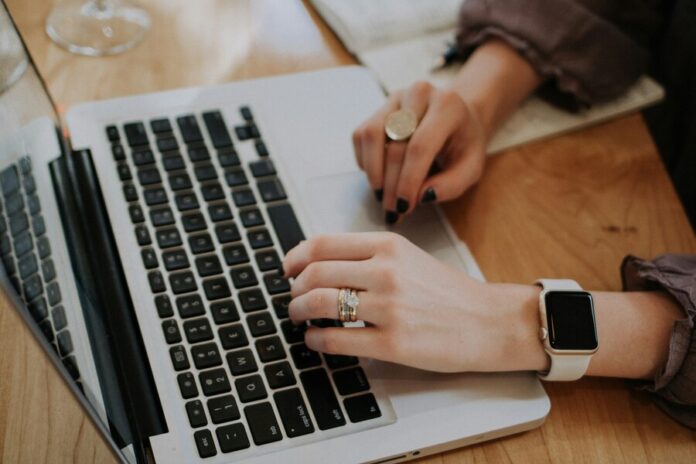 christin-hume-hBuwVLcYTnA-unsplash (1) Woman working using a computer
