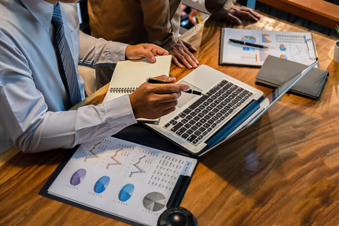 Administrator business man financial inspector and secretary making report calculating balance.