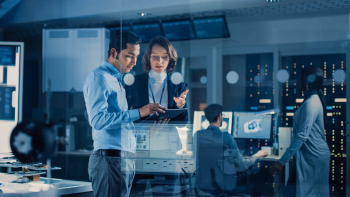 Team of Industrial Engineers, Developers Work on Engine Design Using Computers