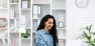 Woman working at her home office, exemplifying remote work with a bright, modern workspace.