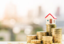 House model on top of coins stack.
