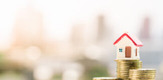 House model on top of coins stack.