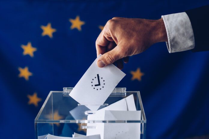 Man throwing his vote into the ballot box