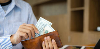 Man holding banknotes counting money