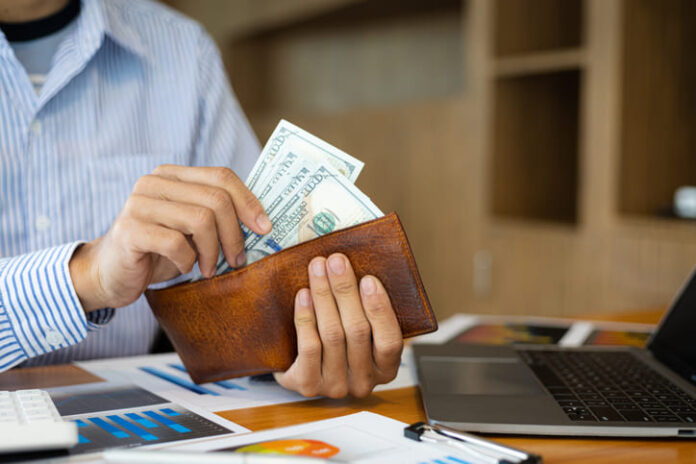 Man holding banknotes counting money