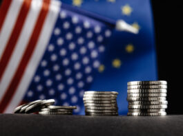 Money of the United States and Europe and two Flags on a dark background