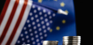 Money of the United States and Europe and two Flags on a dark background