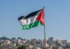 The large Palestinian flag is waiving above the city.