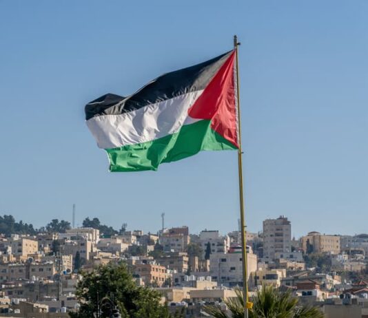 The large Palestinian flag is waiving above the city.