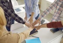 Group of high school or college students join hands