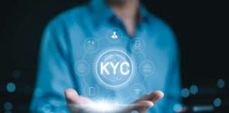Businessman hold glowing digital representation of KYC (Know Your Customer) with compliance and security icons, symbolizing customer identity verification in business