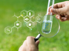 IT-supported Monitoring of Microplastics in Waters Microplastics in food and water, Person with check the water sample in a test tube.