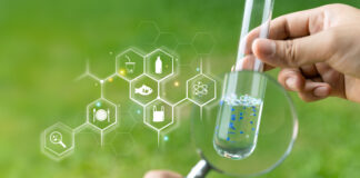Microplastics in food and water, Person with check the water sample in a test tube.