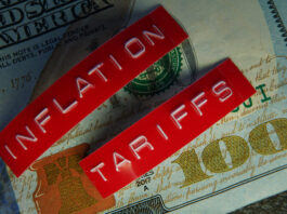 TARIFFS GUERRILLA: An Attempt to Tackle US Inflation Amid Growing World Trade Tensions Red Tariffs and Inflation labels on a hundred dollar bill