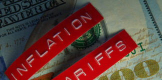 Red Tariffs and Inflation labels on a hundred dollar bill