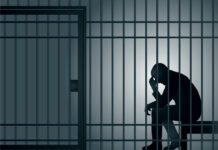 man imprisoned in a cell