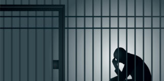 man imprisoned in a cell