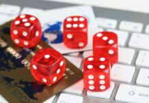 Dice plastic credit bank cards and computer keyboard on table