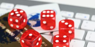 Dice plastic credit bank cards and computer keyboard on table