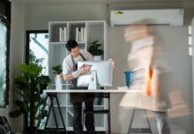 Professional Office Cleaning with Focused Worker and Motion Blur of Colleague in Modern Workspace