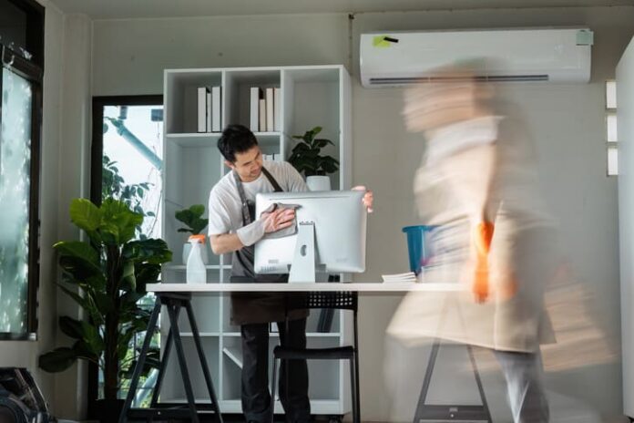 Professional Office Cleaning with Focused Worker and Motion Blur of Colleague in Modern Workspace