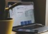 black and silver laptop computer beside yellow ceramic mug