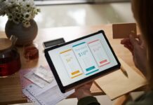 Closeup image of female customer paying for service subscription with credit card