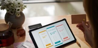 Closeup image of female customer paying for service subscription with credit card
