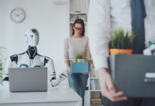 Dismissed business people packing their belongings and leaving the office, a robot is sitting at the desk and working