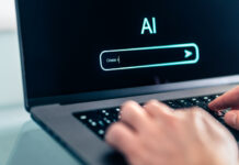 Man using computer with artificial intelligence app. Virtual assistant in digital creative work.