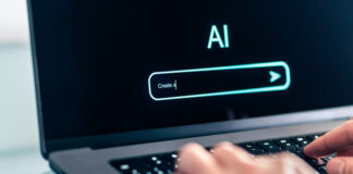 Man using computer with artificial intelligence app. Virtual assistant in digital creative work.