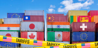 Shipping containers adorned with global flags, barricaded by US Tariffs tape