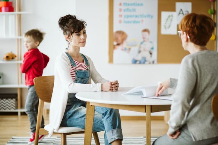 ADHD child's therapist talk with mother and ask questions during first session