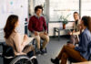 Multiracial group of business colleagues brainstorming during presentation in the office.