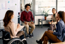 Multiracial group of business colleagues brainstorming during presentation in the office.