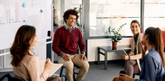 Multiracial group of business colleagues brainstorming during presentation in the office.