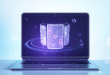 Close up of laptop computer with creative digital blue cards on screen on light background. Online casino, poker and digital gaming