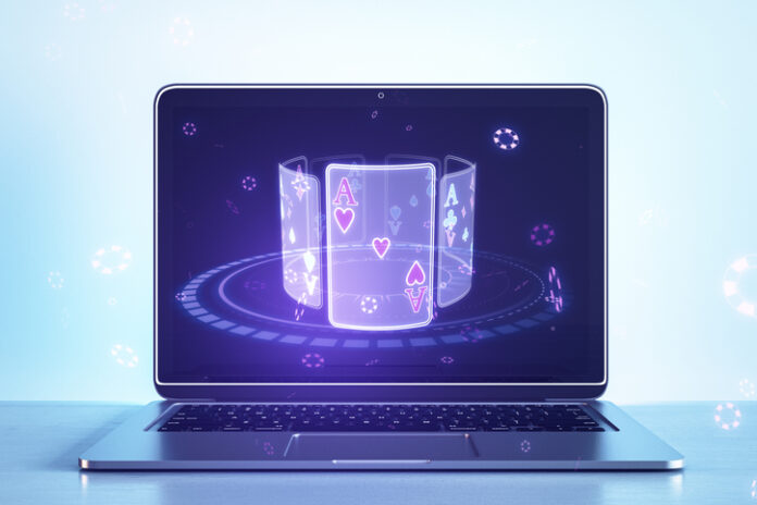 Close up of laptop computer with creative digital blue cards on screen on light background. Online casino, poker and digital gaming concept. 3D Rendering. Close up of laptop computer with creative digital blue cards on screen on light background. Online casino, poker and digital gaming