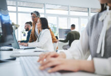 Software, technology and teamwork with employees and computer for data, research and coaching with their manager