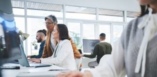 Software, technology and teamwork with employees and computer for data, research and coaching with their manager