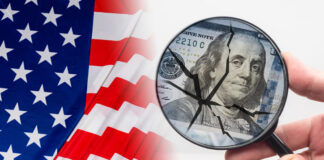 Hand with a magnifying glass in front of dollars. Crack as a symbol of US federal economy destruction
