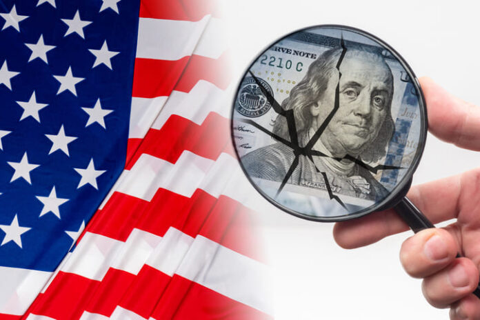Hand with a magnifying glass in front of dollars. Crack as a symbol of US federal economy destruction
