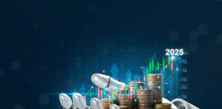 Robot Hand holding stacking pile of coins and analyzing the stock market.Using AI in Business to Achieve Goals.