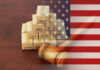 Judge gavel with heap of shipping carton boxes and USA national flag.