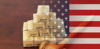 Judge gavel with heap of shipping carton boxes and USA national flag.