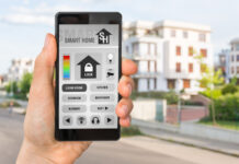 Smartphone with remote smart home control system - futuristic smart home concept